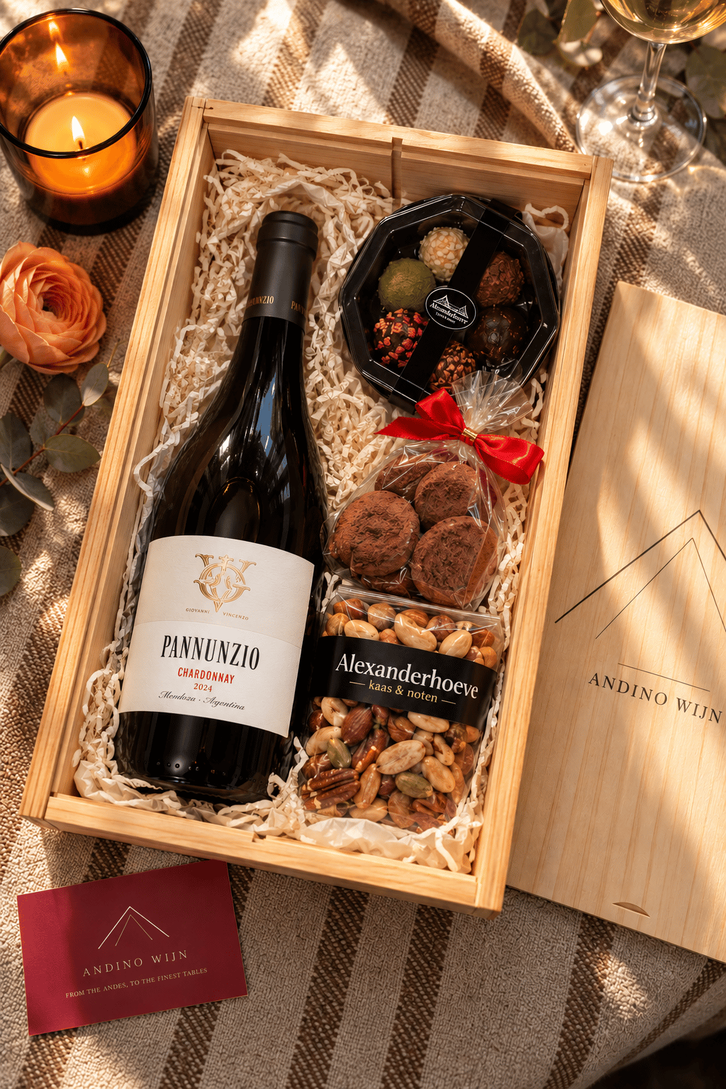 An Andino Wijn corporate gift box with a bottle of Pannunzio Chardonnay, chocolates and seasonal treats, candlelit at golden hour