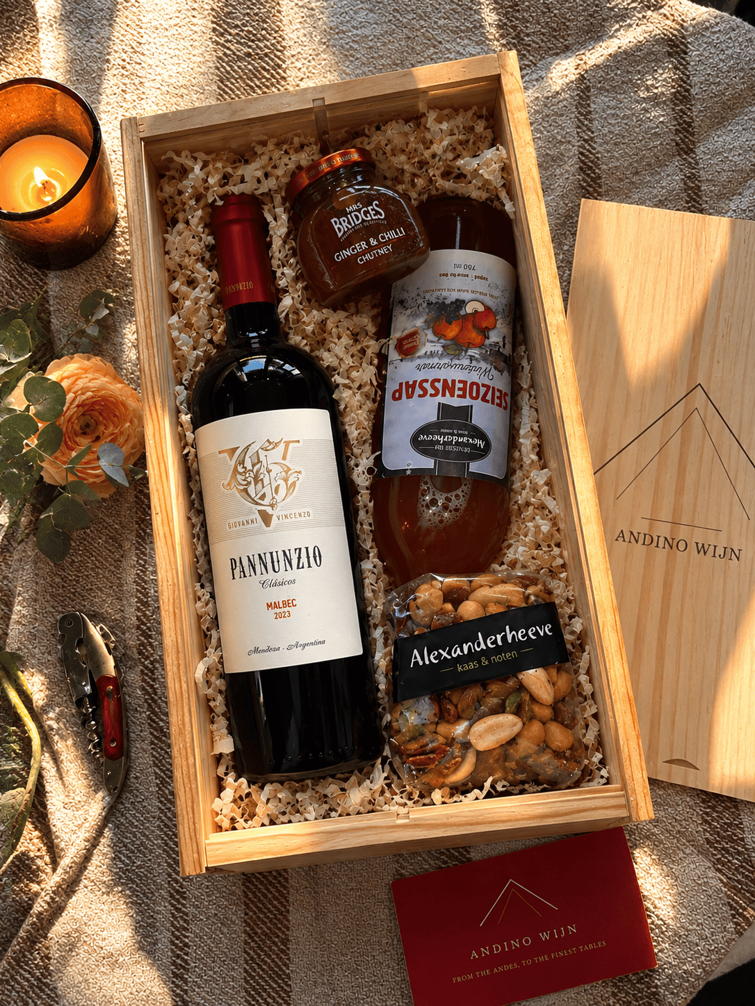 An Andino Wijn corporate gift box holding a bottle of Pannunzio Malbec, a jar of ginger and chilli chutney, a bottle of Seizoenssap Winterwarmer and mixed nuts